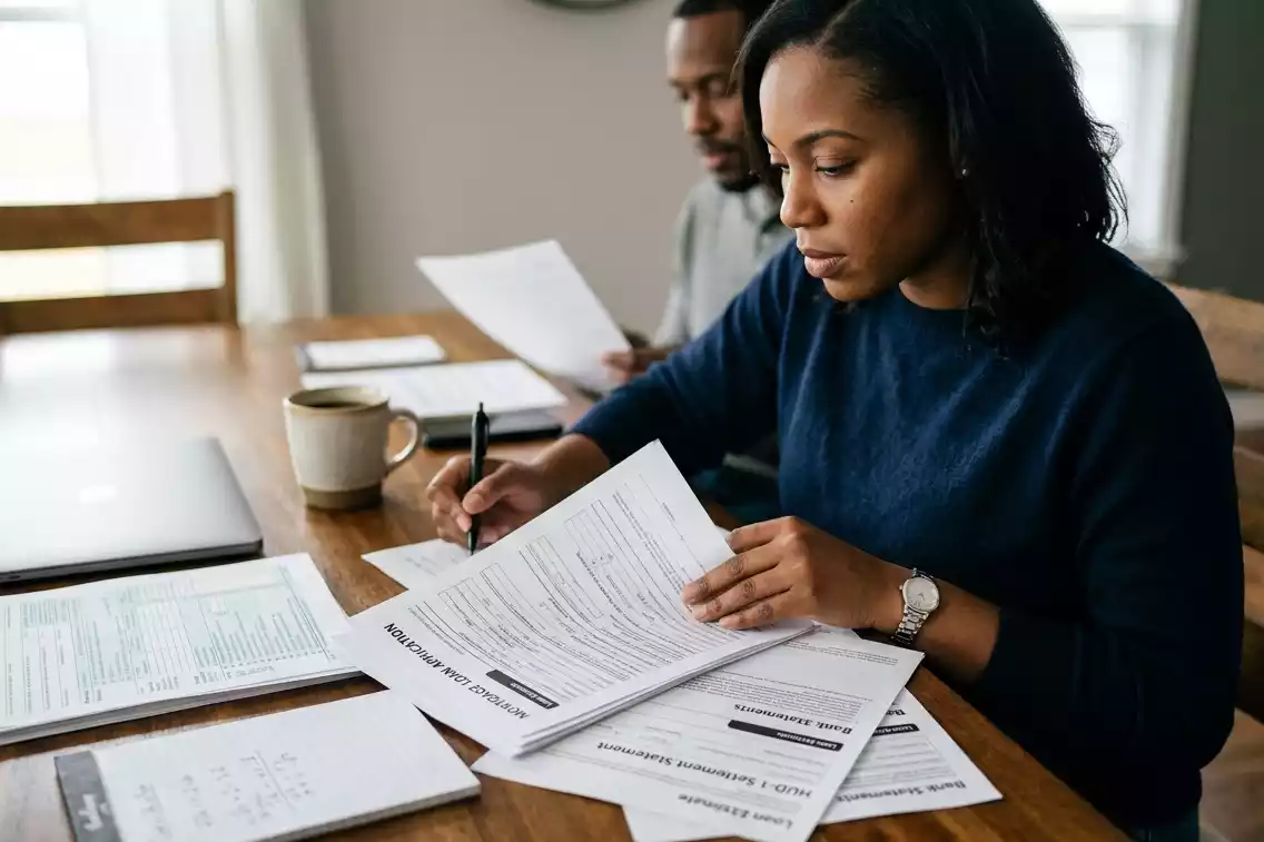 Homebuyer organizing mortgage application documents